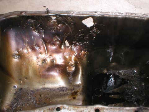 1978 Ford Bronco - This is a used oil pan, heavily coated in sludge and showing signs of damage.