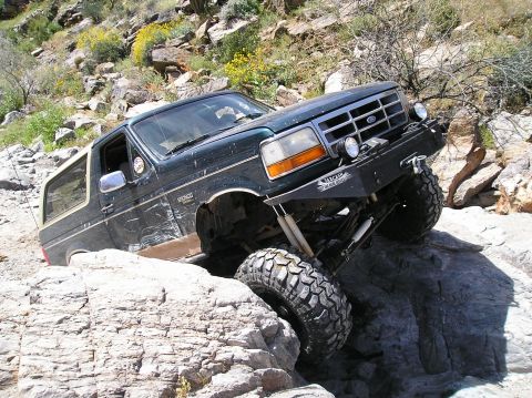 1993 Ford Bronco - This 1993 Ford Bronco is shown off-roading through a challenging rocky landscape.