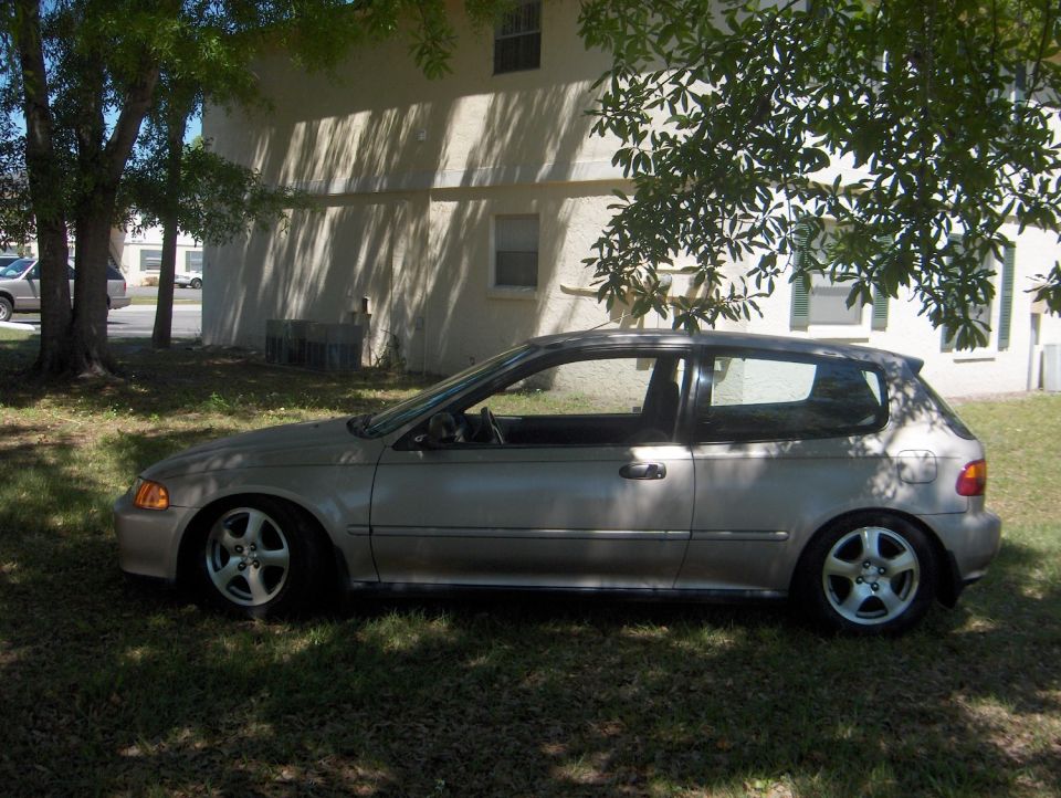 Silver 1990s Honda Civic hatchback lowered on alloy wheels parked on grass