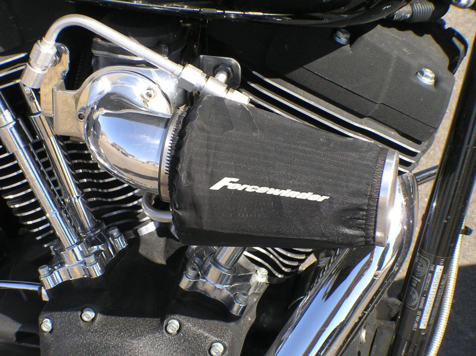 Chrome motorcycle air intake with black Forcewinder filter cover on a V-twin engine
