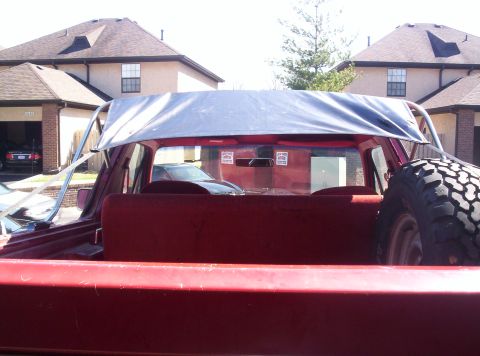 1989 Ford Bronco - Rear view of a red 1989 Ford Bronco, a custom bikini top and a spare tire mounted externally.
