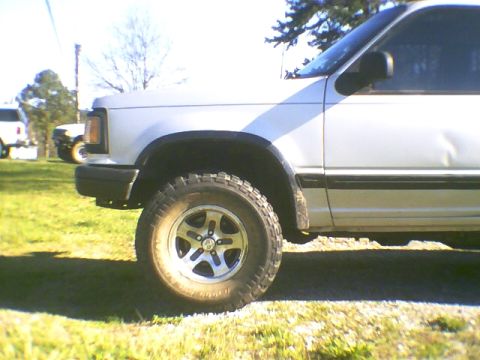 1991 Mazda Navajo - A white SUV is parked outdoors on a sunny day, with another vehicle visible in the background.