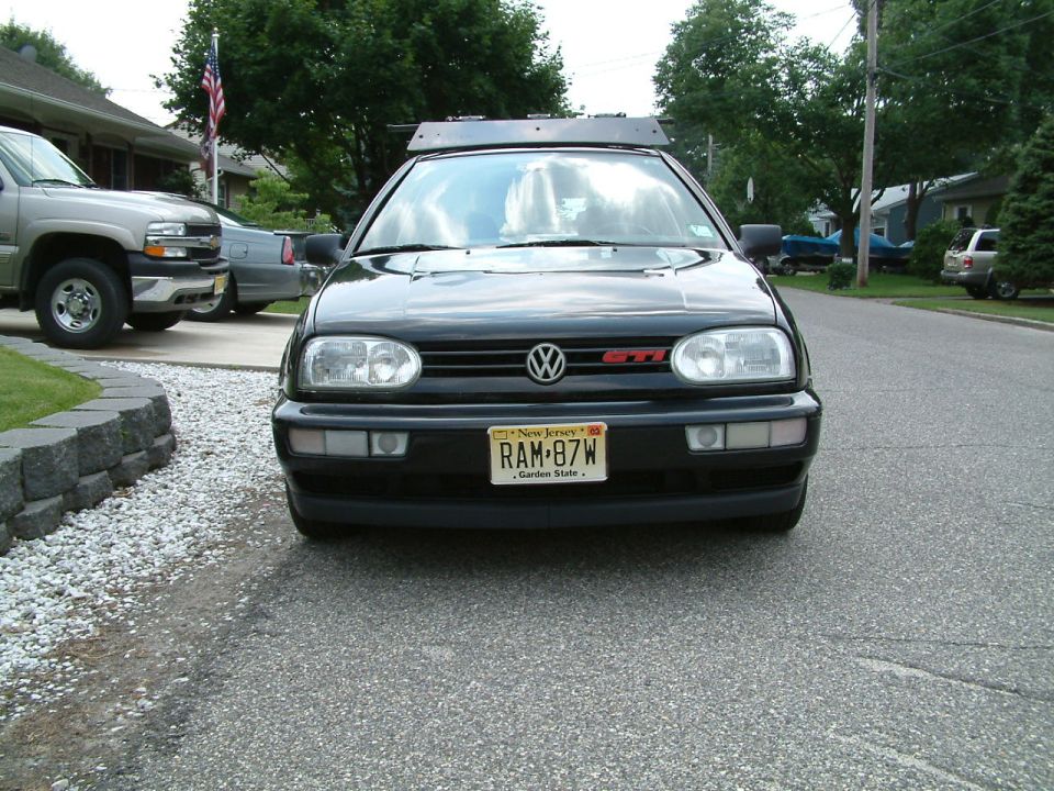 Black Volkswagen GTI front view with a roof rack and New Jersey license plate RAM-87W