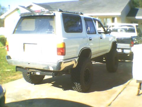 1991 Mazda Navajo - Rear view of a lifted 1991 Mazda Navajo SUV with off-road tires. A second vehicle is parked behind it.