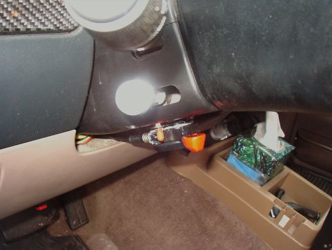 1993 Ford Bronco - Close-up view of the dashboard and center console area of a vehicle, showing various controls and a tissue box.