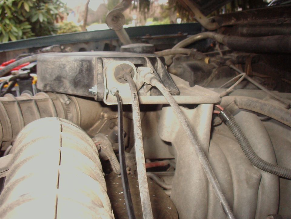 Engine bay with air intake tube and black box with wires