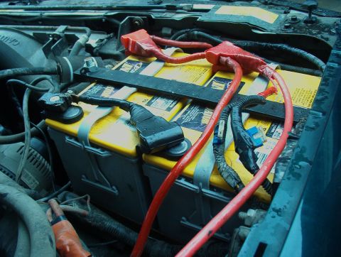 1993 Ford Bronco - Dual battery setup with red and black cables connected in an engine bay.