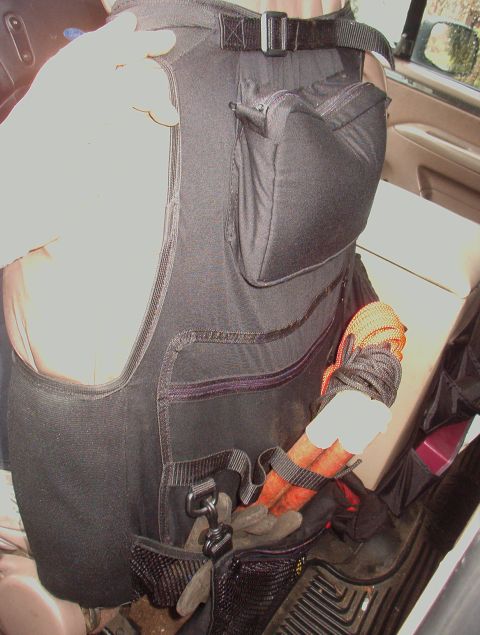 1993 Ford Bronco - Tool vest with gear, possibly inside a vehicle.