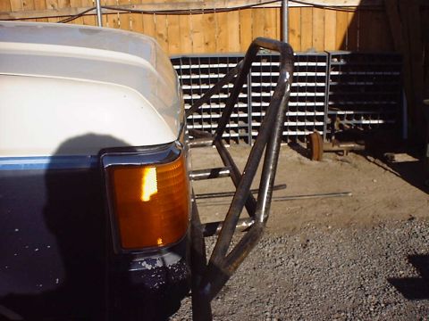 1988 Ford Bronco - Custom prerunner bumper attached to the front corner of a white and blue 1988 Ford Bronco.