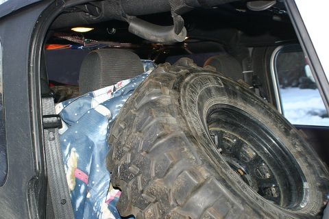 2003 Jeep TJ - A spare tire and blankets are stored in the rear of the vehicle.