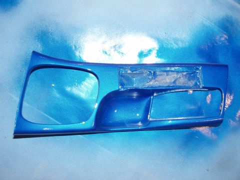 1994 Ford Probe - A metallic blue interior door panel is shown, likely for a car, with openings for the window crank and door handle.