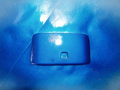 1994 Ford Probe - This blue plastic trim piece has a textured surface and a small square opening.