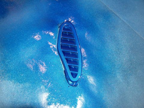 1994 Ford Probe - Close-up of a blue vent on a blue car's bodywork.