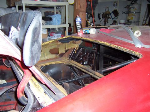 1971 Ford Mustang - Interior of a car undergoing restoration, showing a roll cage and exposed metalwork.