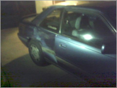 1989 Mazda MX-6 - A blue coupe is parked outdoors at night, with its side profile visible.