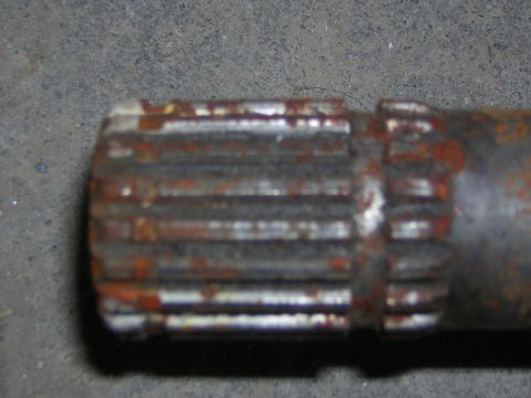 1995 Ford Bronco - This is a close-up view of a rusted metal shaft with splines.