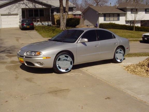 Silver sedan with chrome hubcaps parked in a driveway