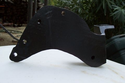 1994 Ford F-150 - A black metal bracket, likely a suspension component, is shown against an outdoor background.