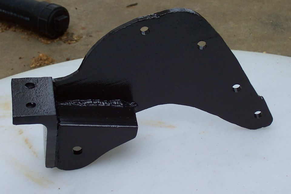 Freshly painted black fabricated steel mounting bracket with welded gusset and bolt holes