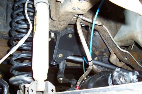 1994 Ford F-150 - Undercarriage view showing suspension parts including a coil spring and shock absorber.