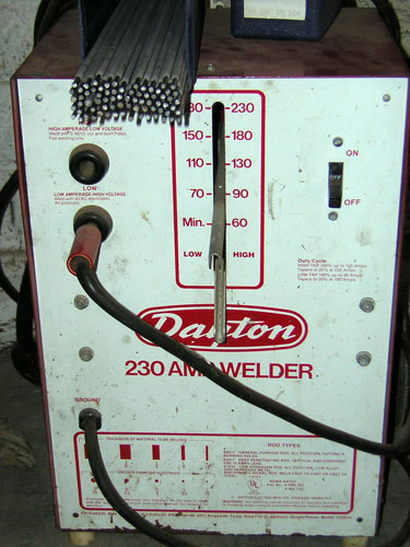 1995 Ford Bronco - A Dayton 230 amp stick welder with a white and maroon front panel, its amperage selector lever set near the middle of the 60-230 range and…