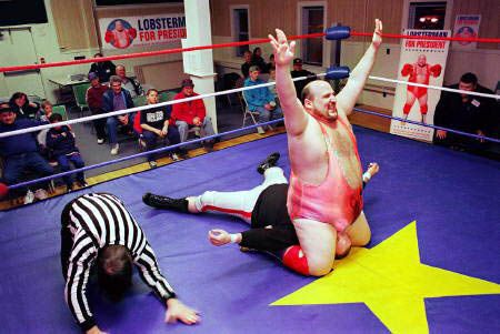 1990 Ford Bronco - A wrestling match is underway with a referee and audience present.