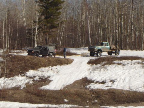 1978 Chevrolet C/K Pickup - Two trucks, a Ford F-Series and a dark SUV, are parked in a snowy, wooded area.