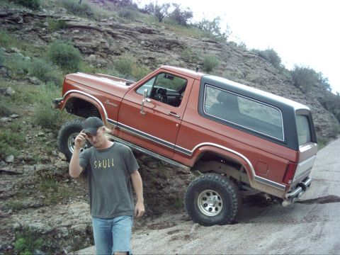 1988 Ford Bronco - Ford Bronco navigating rough terrain on a dirt path.