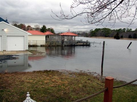 1995 Ford Bronco - A backyard scene shows significant flooding around a garage and dock area.
