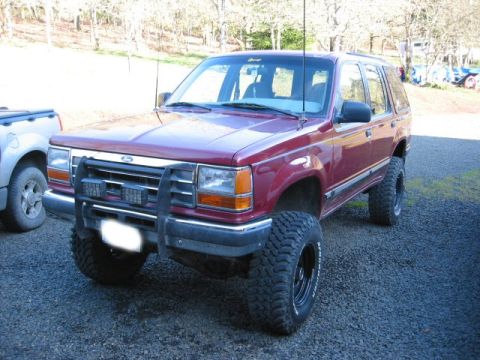 1991 Ford Explorer - This 1991 Ford Explorer features a prominent bull bar and aggressive off-road tires, giving it a appearance.