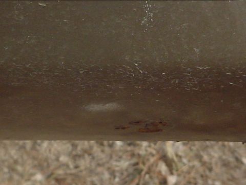 1979 Ford Bronco - A close-up view of a vehicle's body panel, showing signs of wear and minor rust.
