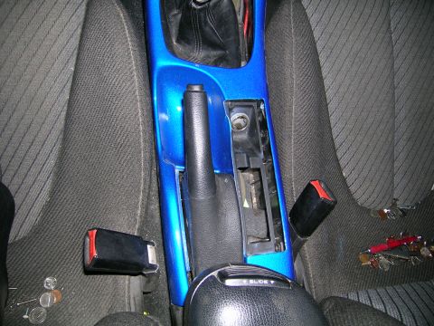 1994 Ford Probe - The interior of a car shows a disassembled center console with a bright blue painted trim piece.