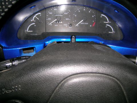 1994 Ford Probe - Close-up of a car's interior dashboard, showing the instrument cluster and steering wheel.