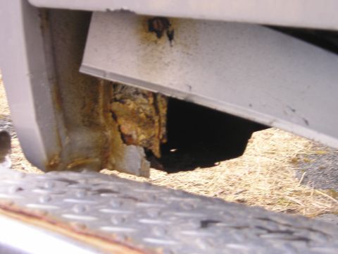 1984 Ford Bronco - Significant rust damage is visible on the vehicle's frame and body panels.