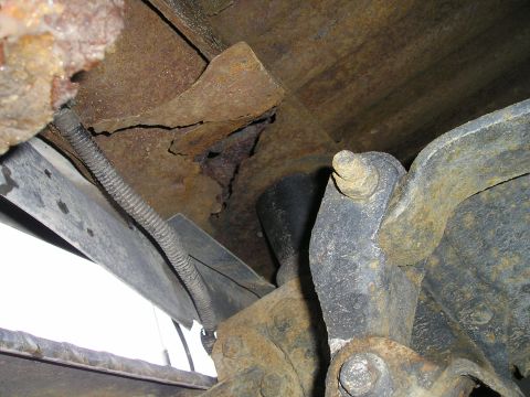 1984 Ford Bronco - Extensive rust damage is visible on the frame and suspension components of this vehicle.