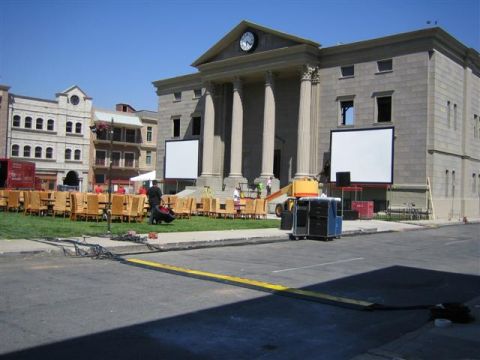 1994 Ford Bronco - A film set is prepared with chairs and screens in front of a large building.