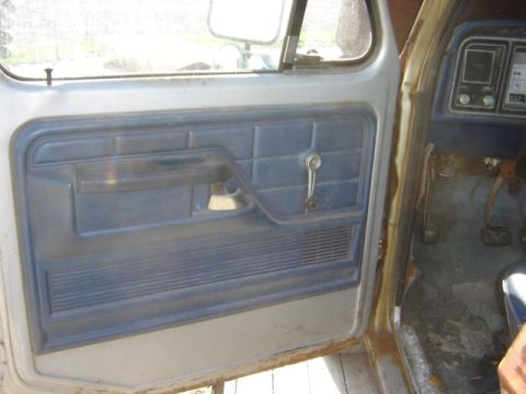 1992 Ford Bronco - Driver's side interior view of a 1979 Ford F-Series truck, focusing on the door panel and dash.