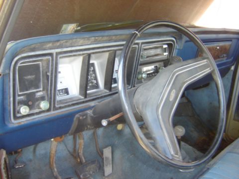 1992 Ford Bronco - The interior of an older truck, the dashboard, steering wheel, and instrument cluster.