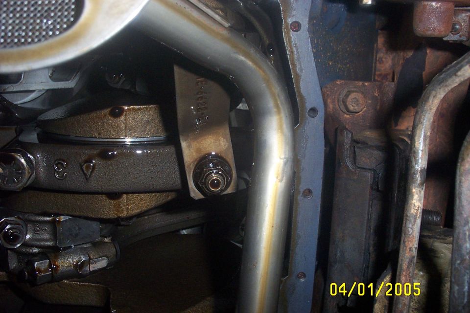 Close-up of engine's oil pan, connecting rods, and some plumbing. Date stamp reads 04/01/2005