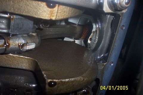1979 Ford F-150 - Close-up view of internal engine components, including the crankshaft and connecting rods, covered in oil.