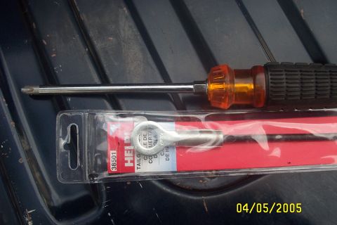 1979 Ford F-150 - A screwdriver and a tailgate cable are shown in their packaging, with the date stamp 04/05/2005 visible.