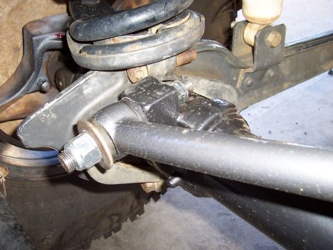 1994 Ford F-150 - This image shows a close-up view of a vehicle's suspension system, focusing on a specific part with a prominent bolt and washer.