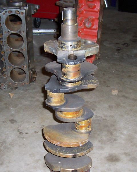 1994 Ford F-150 - A crankshaft and engine block are shown in a workshop setting.