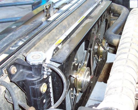 1994 Ford F-150 - Close-up view of a vehicle's radiator and electric fan assembly.
