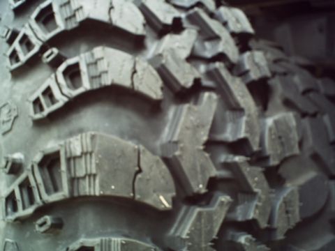 1986 Ford Bronco - This image shows the aggressive tread pattern of an off-road tire, likely for an SUV or truck.