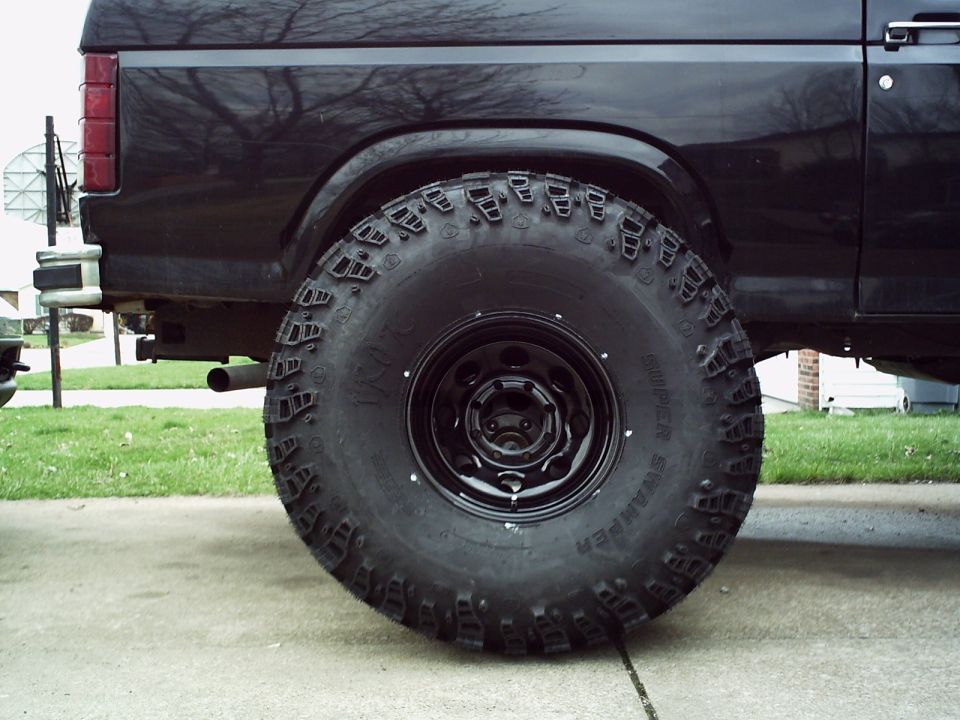 Black SUV rear wheel and fender with large off-road tire