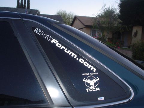 1993 Ford Taurus - A close-up of a car's rear window shows two white decals, one for SHOForum.com and another for West Coast TCCA.