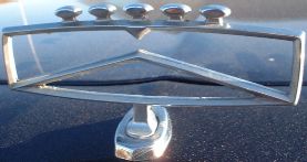 1984 Ford Crown Victoria LTD - A chrome hood ornament with a distinctive angular design is shown in detail.
