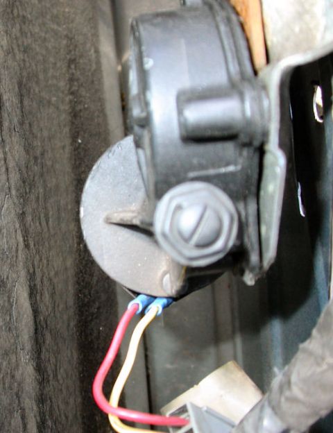 1990 Ford Bronco - the culpret. There are three screws attaching this to the inner door frame. The top and the lower right are easy.