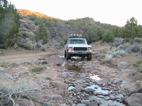 1978 Ford Bronco - 1978 Ford Bronco navigating a rocky stream bed during an off-road excursion.